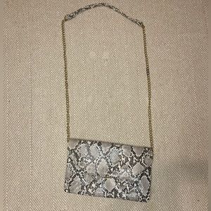 snakeskin bag with three different compartments.